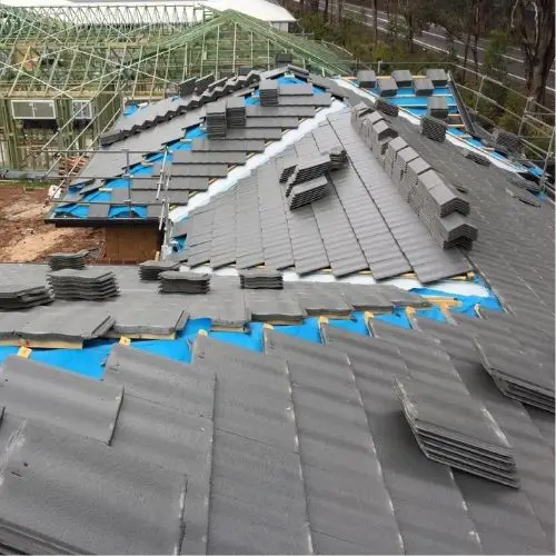 New charcoal concrete tile roof being installed with blue sarking visible — Blue Mountains roofing project